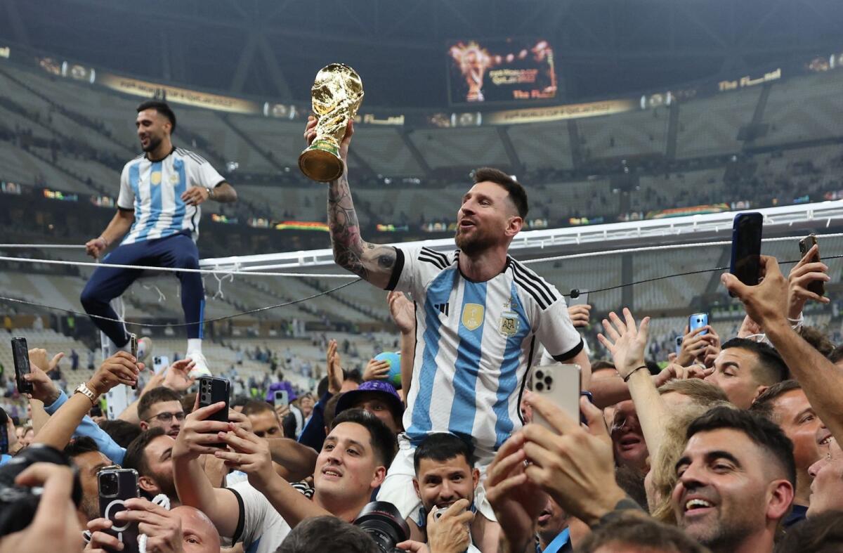 Argentina's Lionel Messi celebrates with the trophy after winning the World Cup. Photo: Reuters