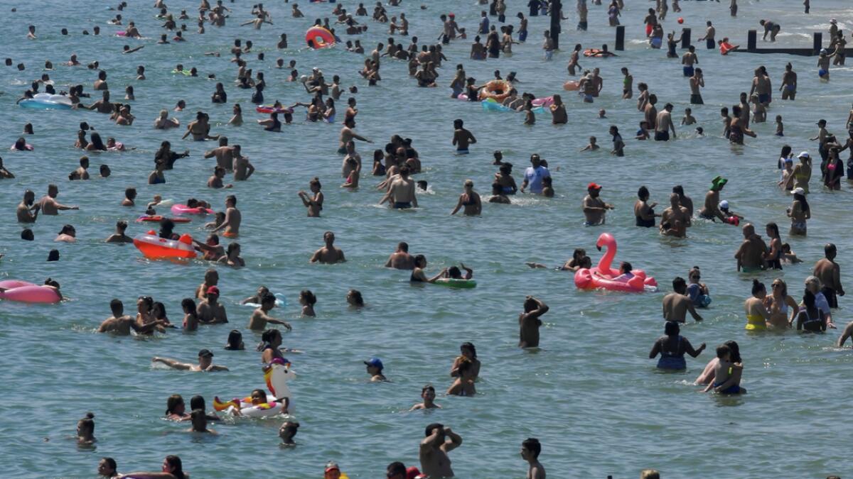 People enjoy the hot weather at the beach in Bournemouth, Britain. Photo: Reuters