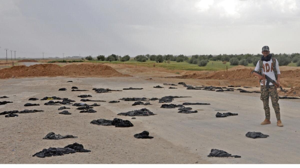  Discarded black veils and burnt cars dot Raqqa as women flee
