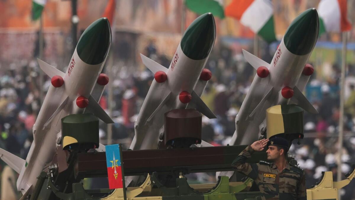 (FILES) In this file photo taken on January 26, 2022 a soldier salutes next to an Akash missile system during India's 73rd Republic Day parade at the Rajpath in New Delhi.Photo: AFP