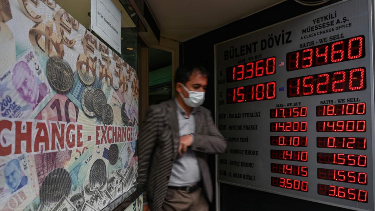 A customer leaves a currency exchange agency near Grand Bazaar in Istanbul. Turkish President Recep Tayyip Erdogan replaced the country's finance minister on December 1, 2021, after weeks of economic turmoil in which inflation has soared while the Turkish lira record a lows. – AFP