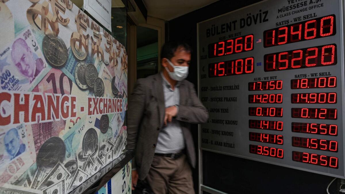 A customer leaves a currency exchange agency near Grand Bazaar in Istanbul. Turkish President Recep Tayyip Erdogan replaced the country's finance minister on December 1, 2021, after weeks of economic turmoil in which inflation has soared while the Turkish lira record a lows. – AFP