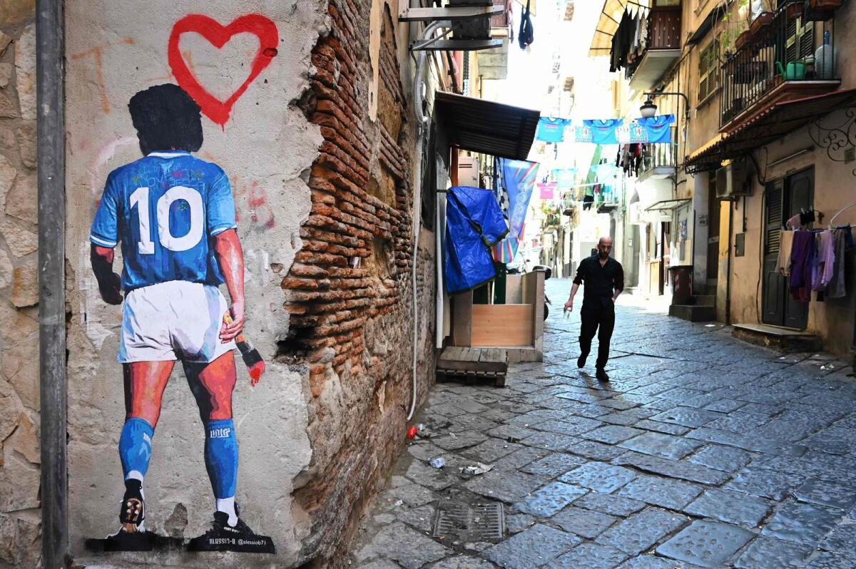 A mural depicting late Argentinian football legend Diego Maradona is seen in the Quartieri Spagnoli district in Naples. — AFP