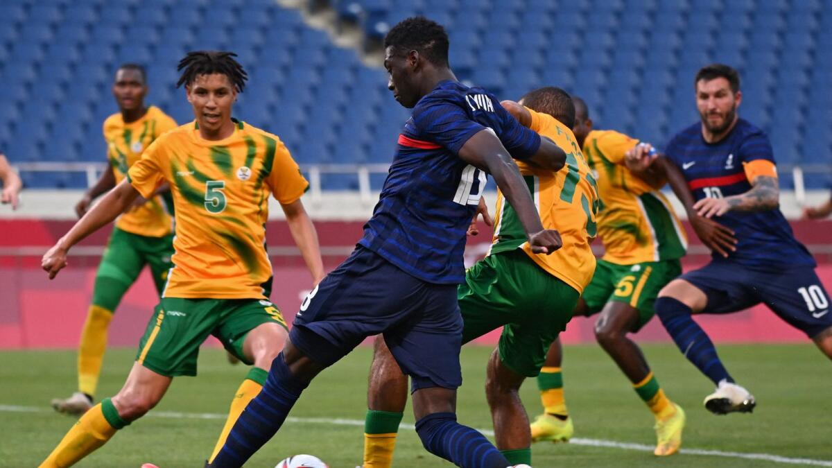 France's forward Randal Kolo Muani (centre) is marked by South Africa's midfielder Reeve Frosler (centre-right) during the Tokyo 2020 Olympic Games men's group A first round match. — AFP