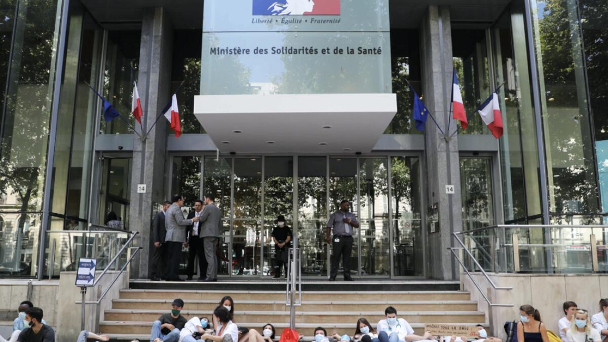 Medical 'interns' stand in front of the entrance to The French Health and Solidarity Ministry in Paris, as they stage a protest to demand better working conditions for health workers. Photo: AFP