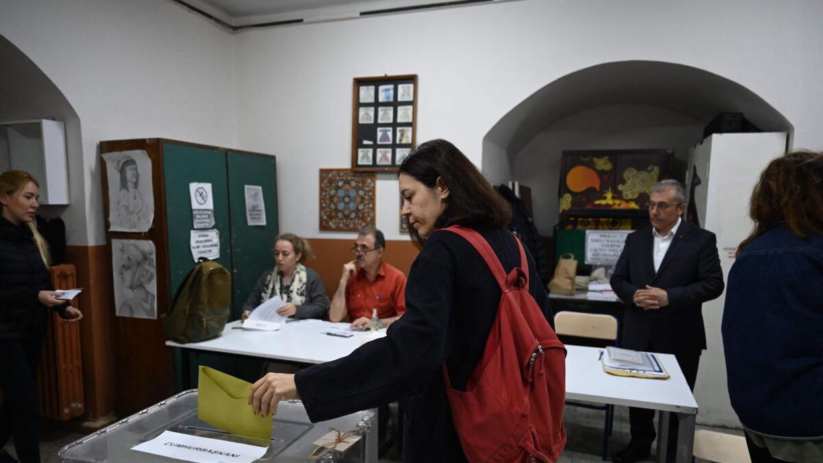 A woman casts her ballot at a polling station during the presidental elections in Istanbul on Sunday.-- AFP