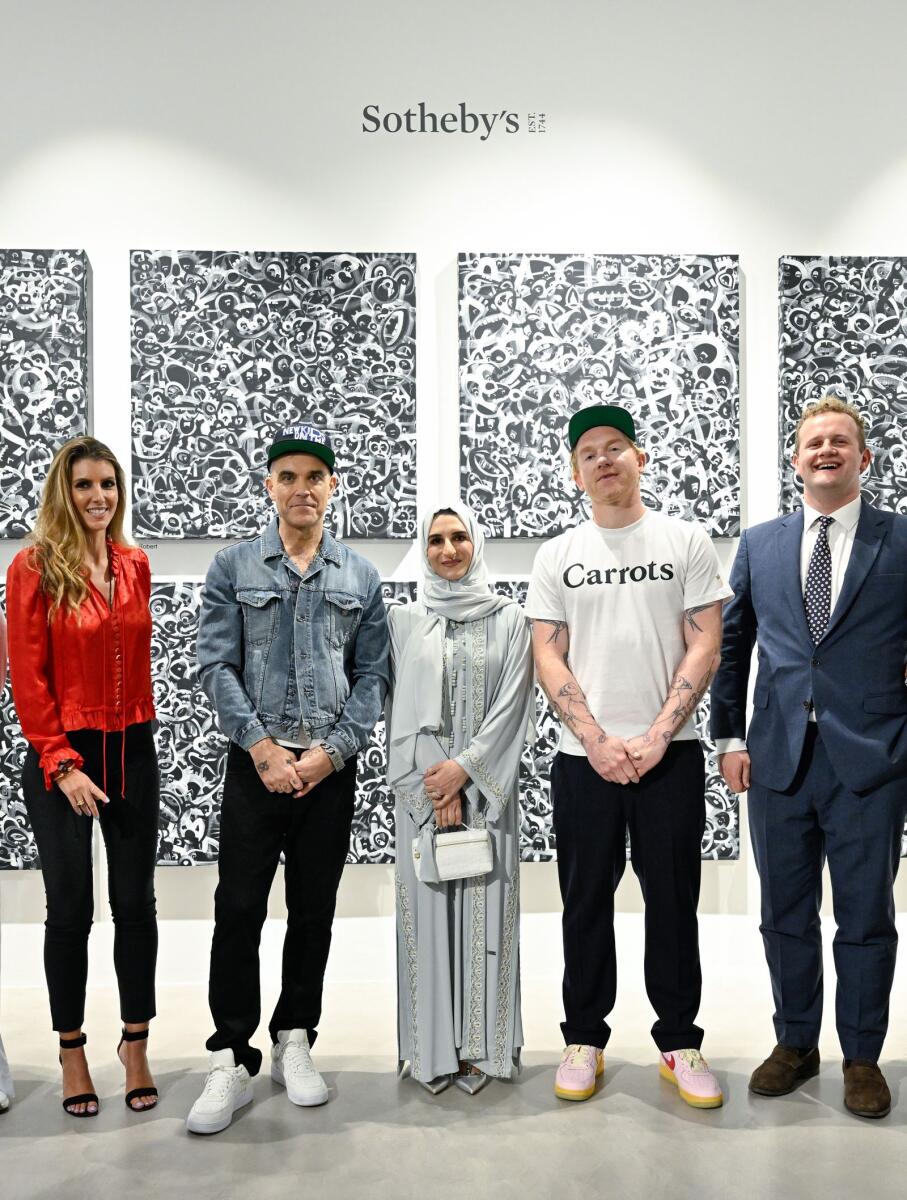 Hala Badri with Katia Nounou-Boeuiz, Robbie Williams, Ed Godrich and Hugo Cobb at the opening of the exhibition at Sotheby's Dubai