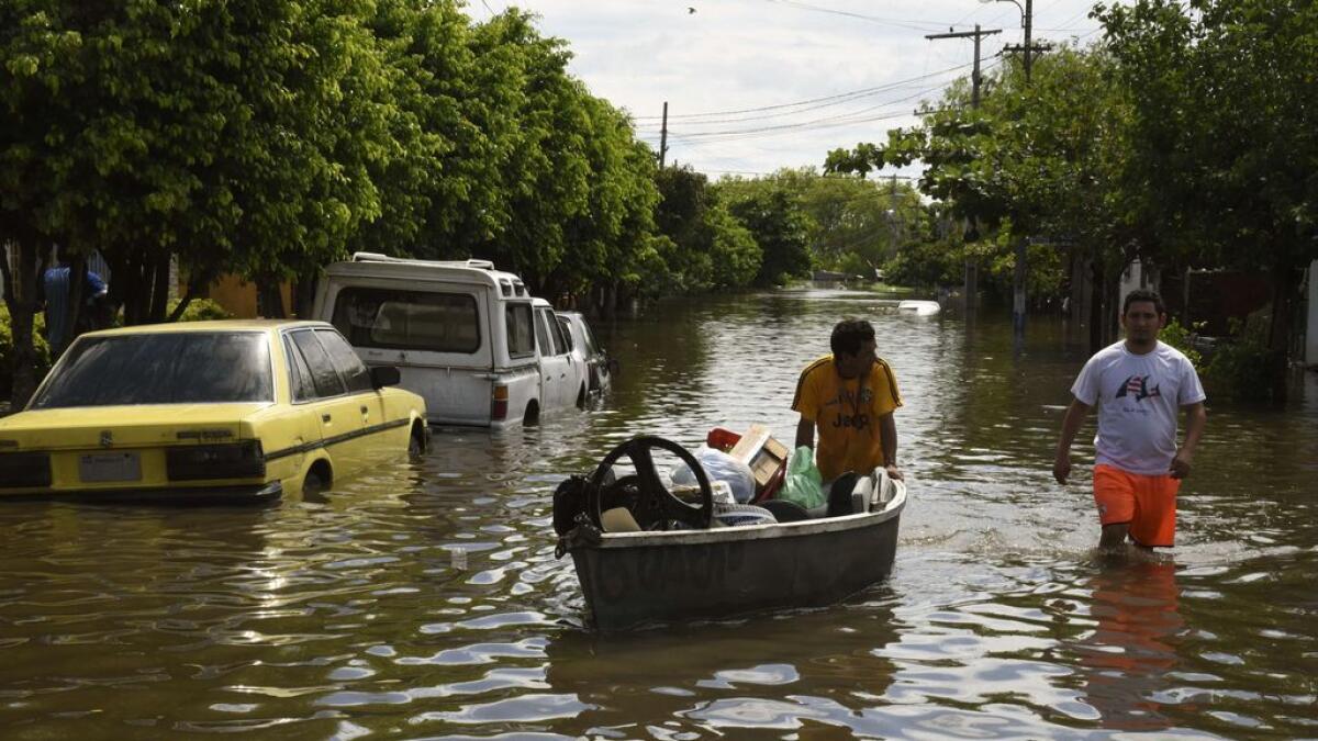 Locals attempt to recover belongings at a flooded neighbourhood in Asuncion, Paraguay.