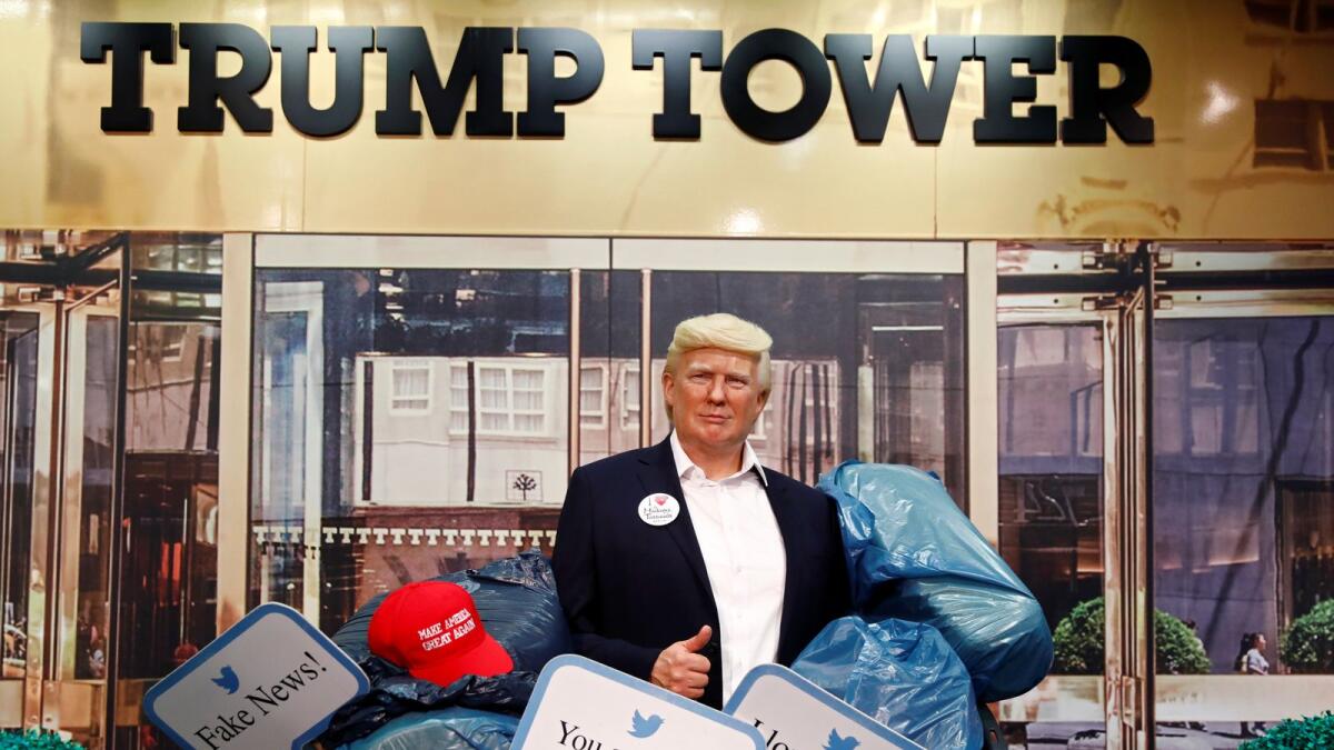 A wax figure depicting US President Donald Trump is put into a dumpster at Madame Tussauds in Berlin, Germany on October 30, 2020.