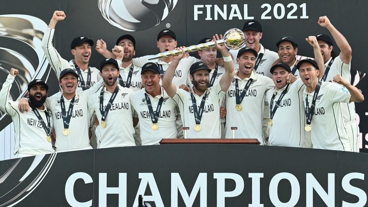 New Zealand's captain Kane Williamson (centre) lifts the winner's Mace as New Zealand players celebrate victory on the final day of the ICC World Test Championship Final against India. — AFP