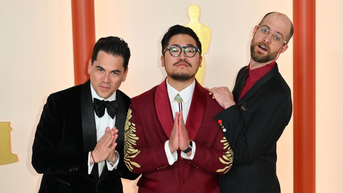 (L-R) US producer Jonathan Wang, US director Daniel Kwan and US director Daniel Scheinert attend the 95th Annual Academy Awards at the Dolby Theatre in Hollywood, California on March 12, 2023. (Photo by AFP)