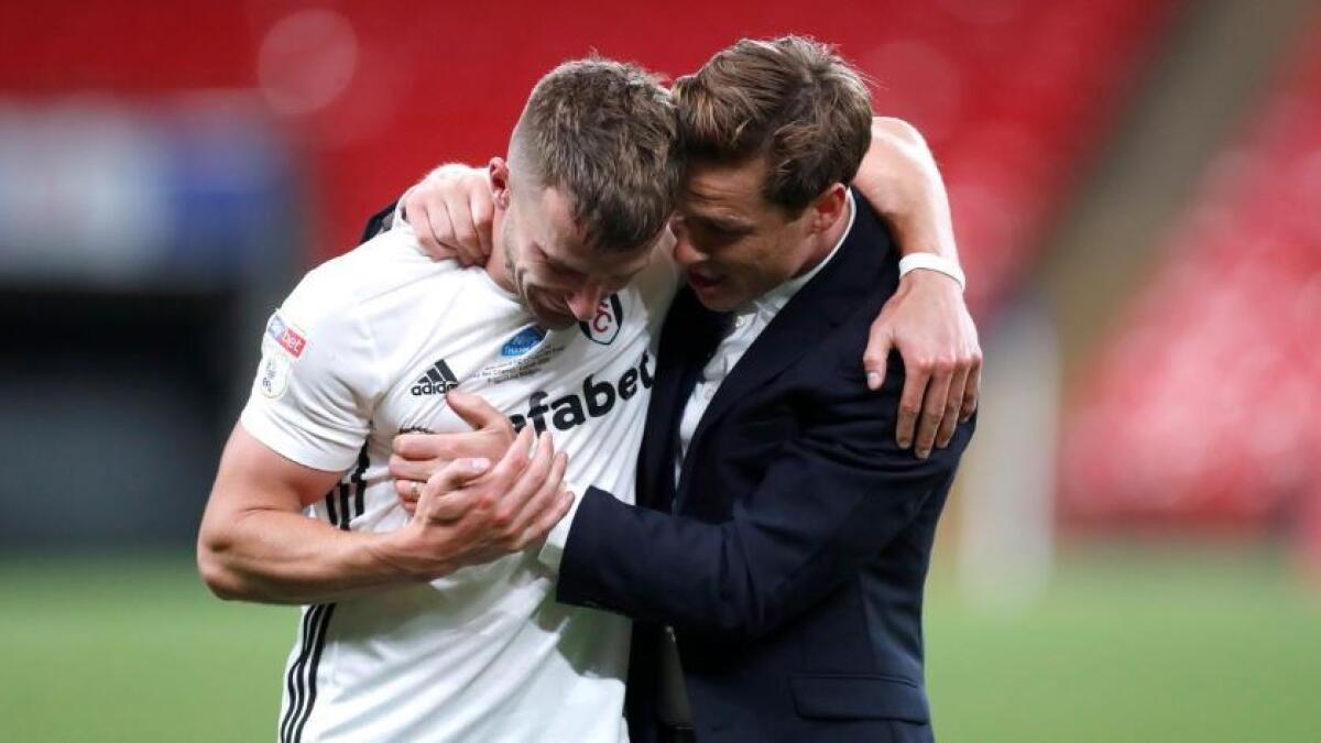 Fulham manager Scott Parker and Joe Bryan celebrate promotion to the Premier League. (Reuters)