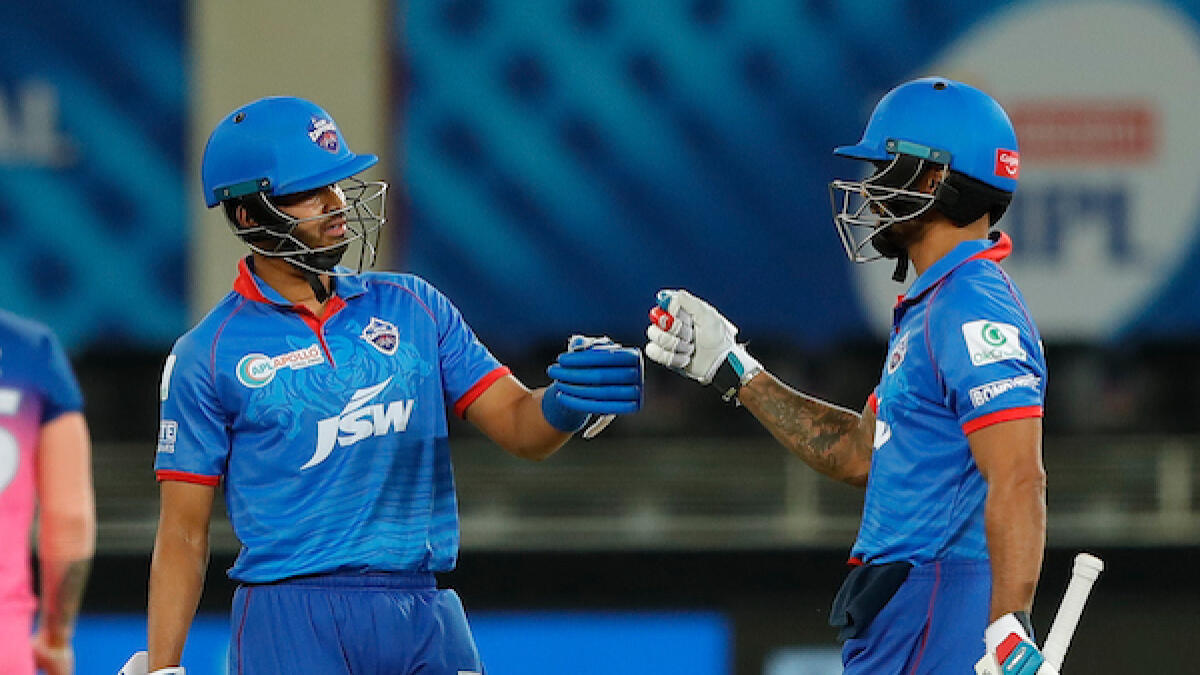 Delhi Capitals captain Shreyas Iyer (left) and Shikhar Dhawan fist bump during the match against Rajasthan Royals in Dubai on Wednesday night. - BCCI/IPL
