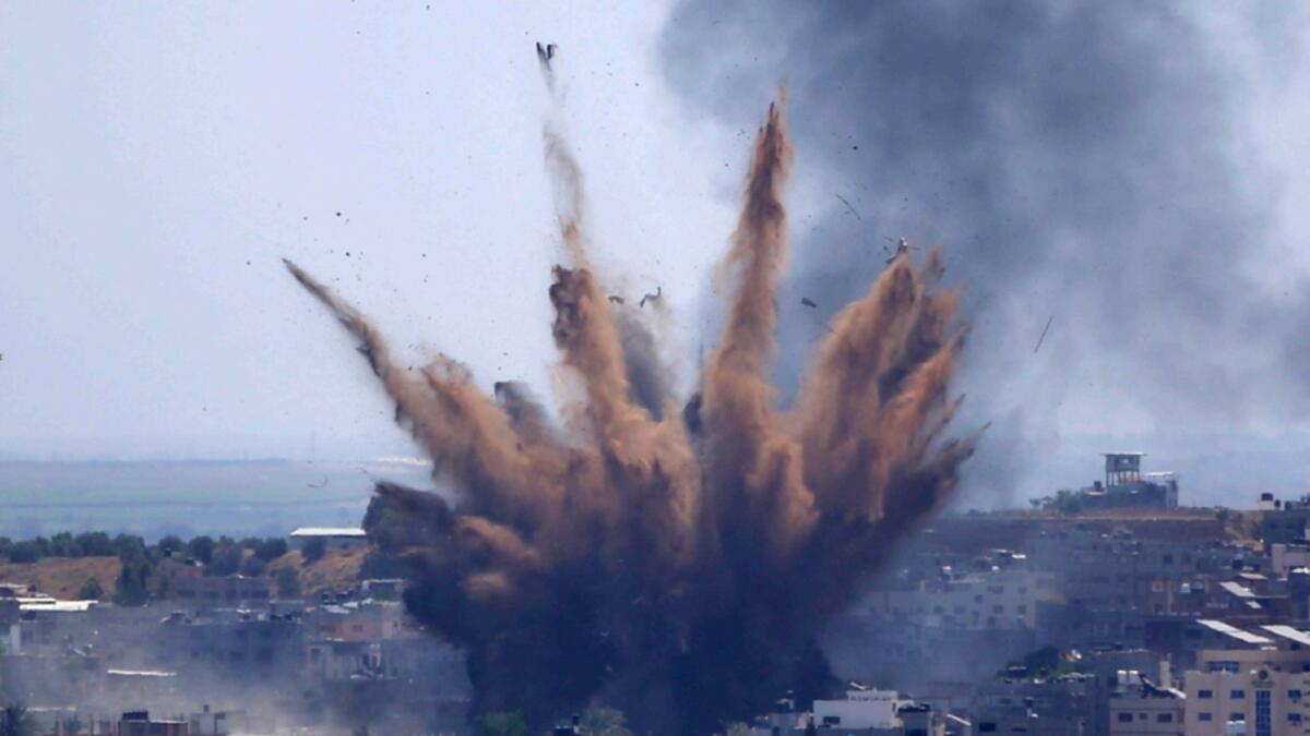 Smoke rises following Israeli air strikes on a building in Gaza City. — AP