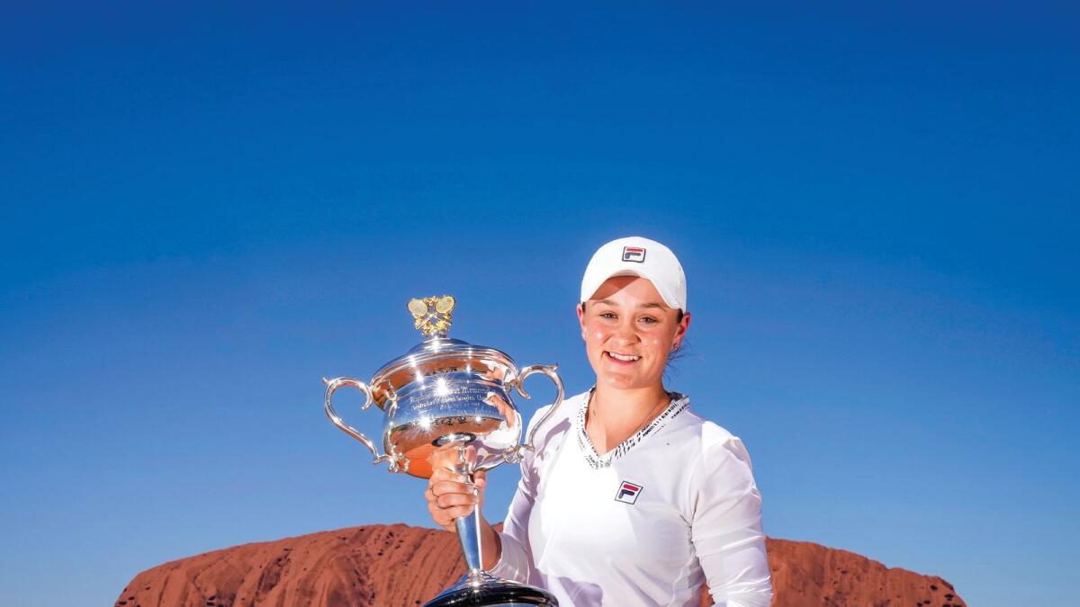 Australia's Ashleigh Barty poses with the Daphne Akhurst Memorial Cup which she won at the Australian Open, during a visit to Uluru in the Uluru-Kata Tjuta National Park. — AFP