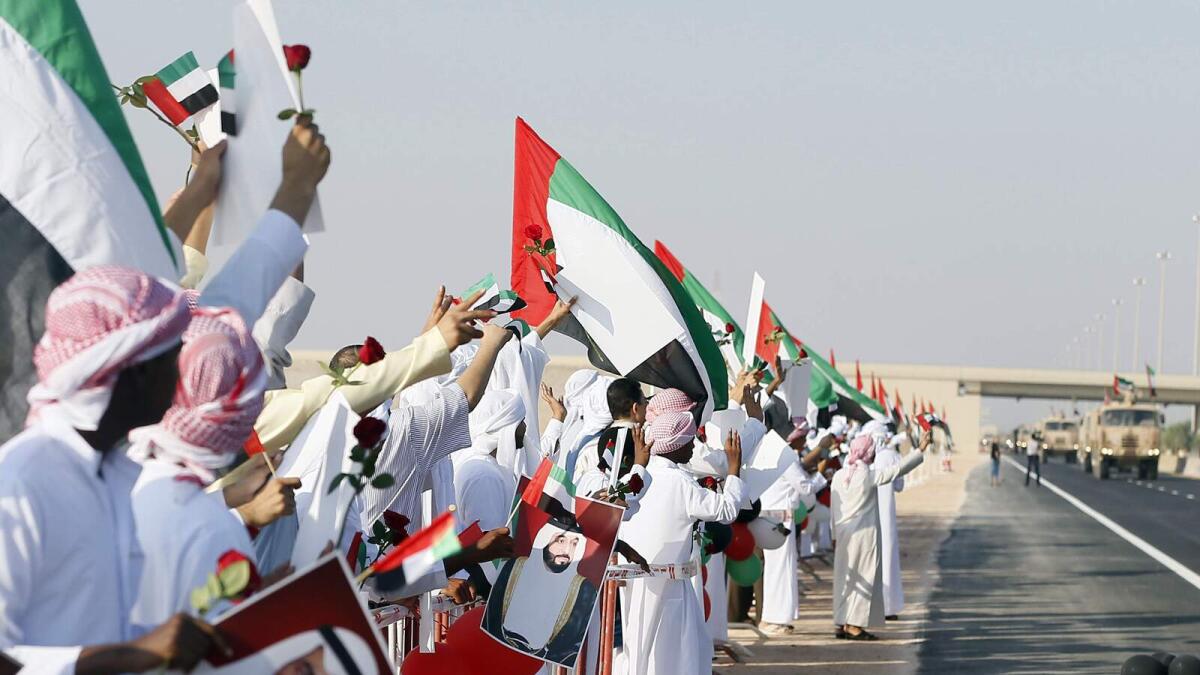 With flags held high UAE soldiers come back home
