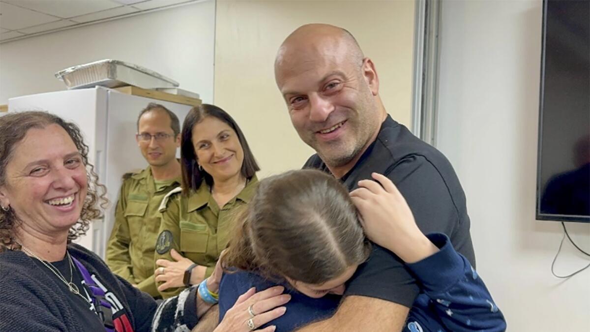 Hila Rotem Shoshani, a released hostage, reunites with her uncle in Israel. — AP