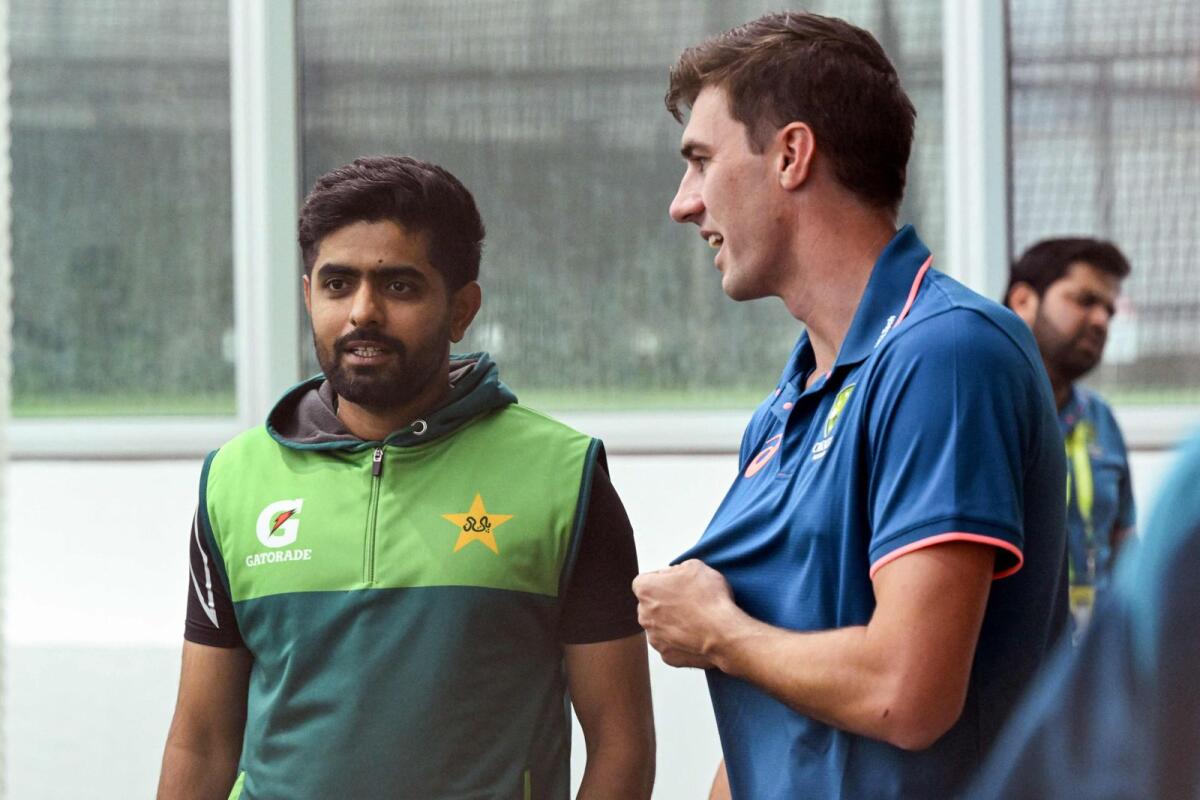 Australia's captain Pat Cummins (right) with Pakistan batsman Babar Azam. — AFP file
