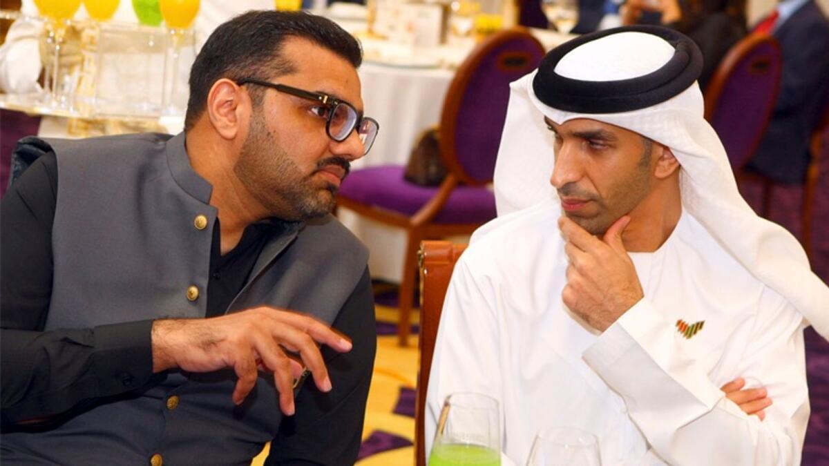 Dr Thani bin Ahmed Al Zeyoudi and Ahmed Shaikhani gesture during the event hosted by Pakistan Business Council, Dubai, on Tuesday. — Photos by Mohammad Mustafa Khan