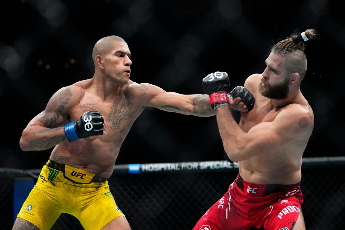 Brazil's Alex Pereira, left, punches Czech Republic's Jirí Procházka during the second round of a light heavyweight title bout at the UFC 295 mixed martial arts event ealry Sunday, Nov. 12, 2023, in New York. - AP