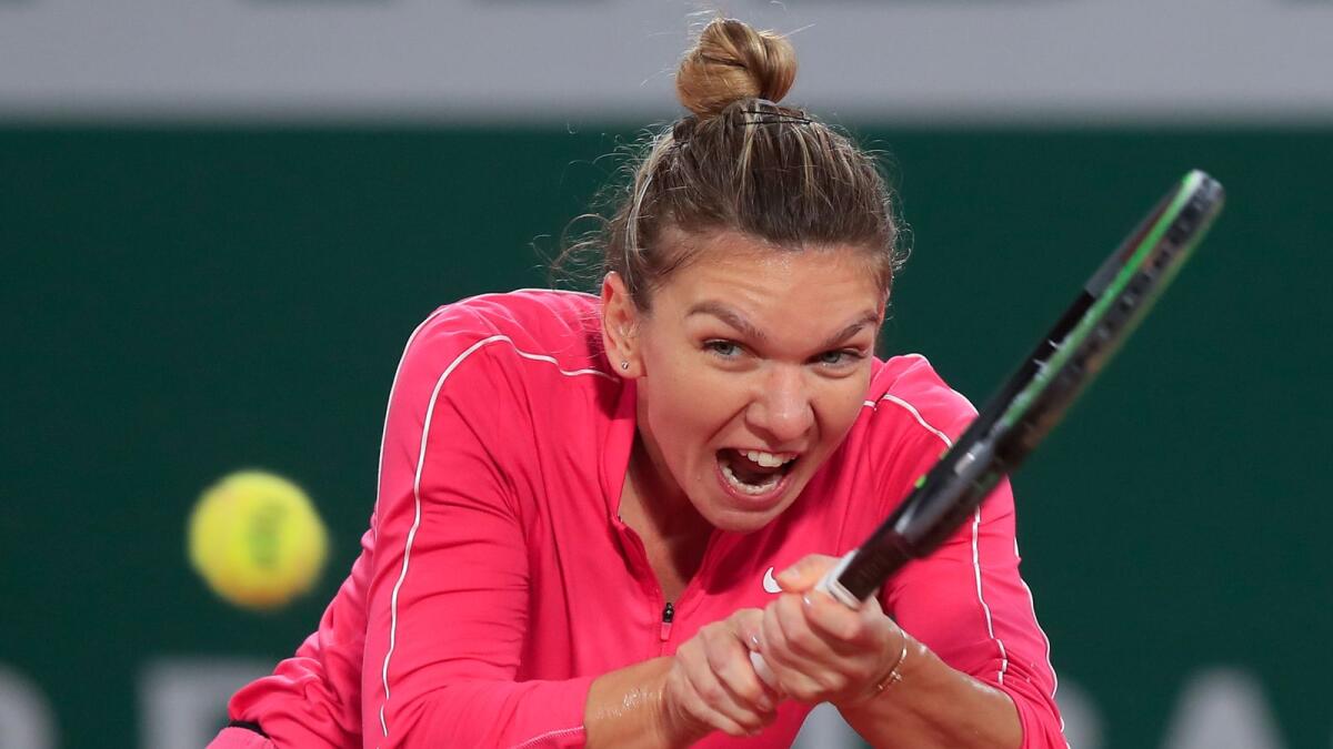 Simona Halep teasts positive but recovering well from mild symptoms. — AP