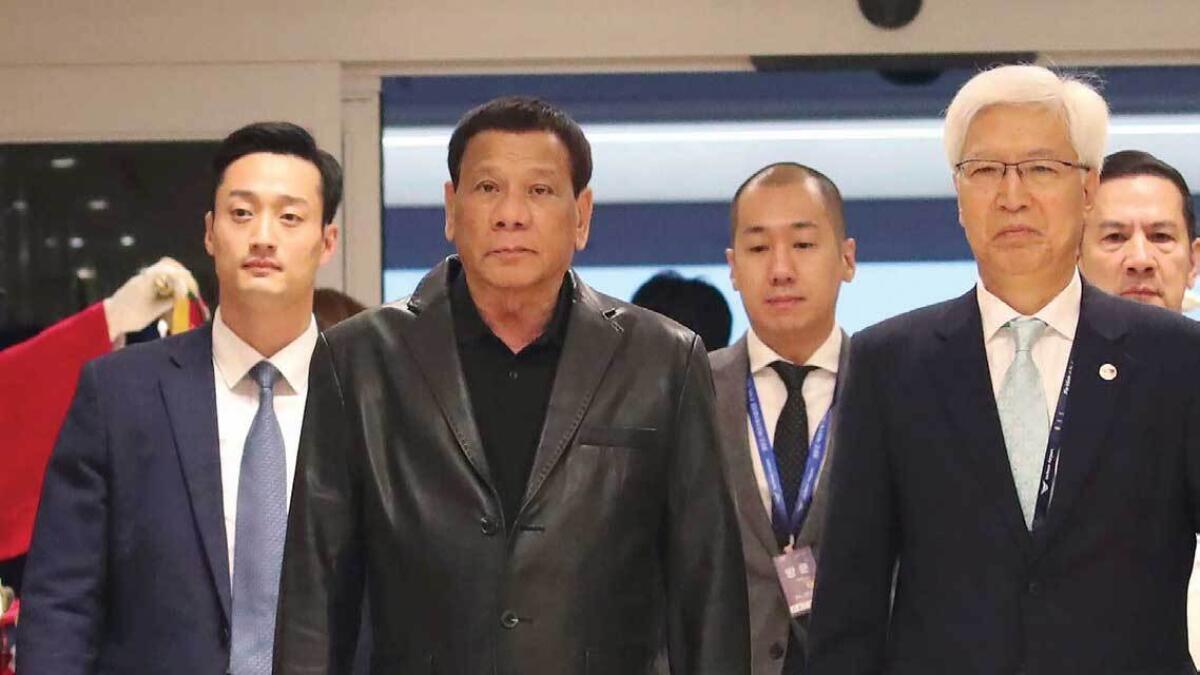 Duterte, second left,  arrives at Incheon International Airport in Incheon, South Korea, on Sunday. — AP