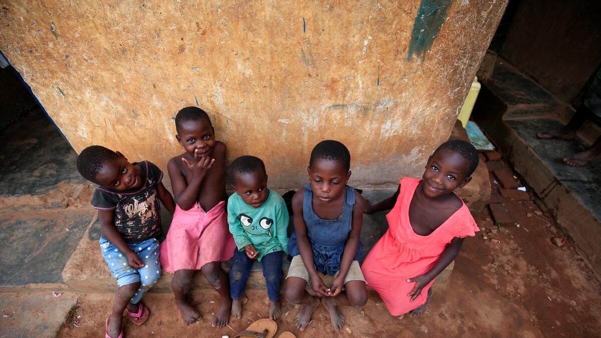 Mariam Nabatanzi's children rest on the verandah at their home in Kasawo village, Mukono district, east of Kampala, Uganda.- Reuters