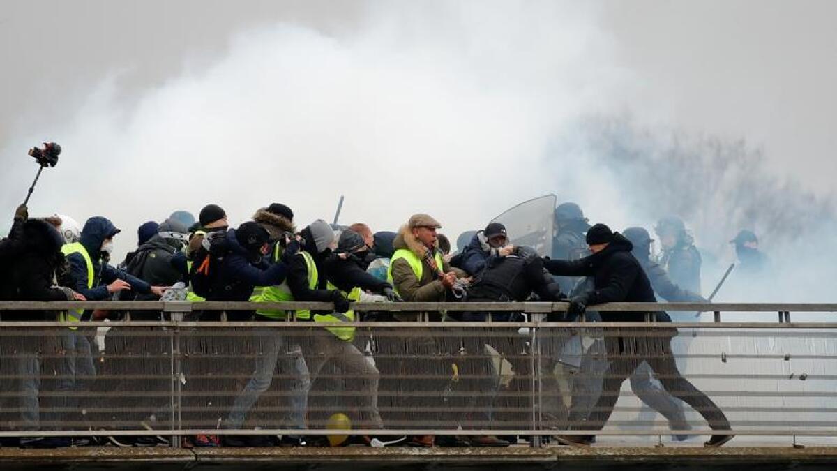 Former French boxing champion, Christophe Dettinger (R), is seen during clashes with French Gendarmes at a demonstration by the 'yellow vests' on the passerelle Leopold-Sedar-Senghor bridge in Paris, France, January 5, 2019. Reuters