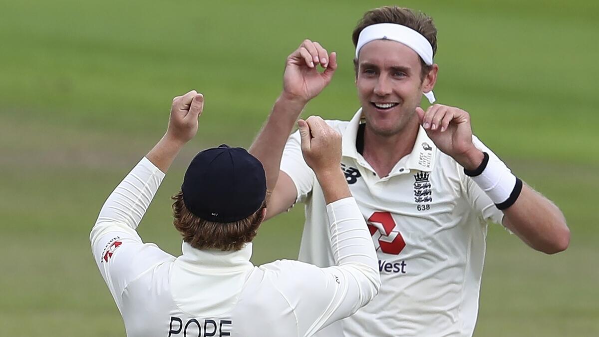 England's Stuart Broad (right) celebrates with teammate Ollie Pope the dismissal of West Indies' Roston Chase