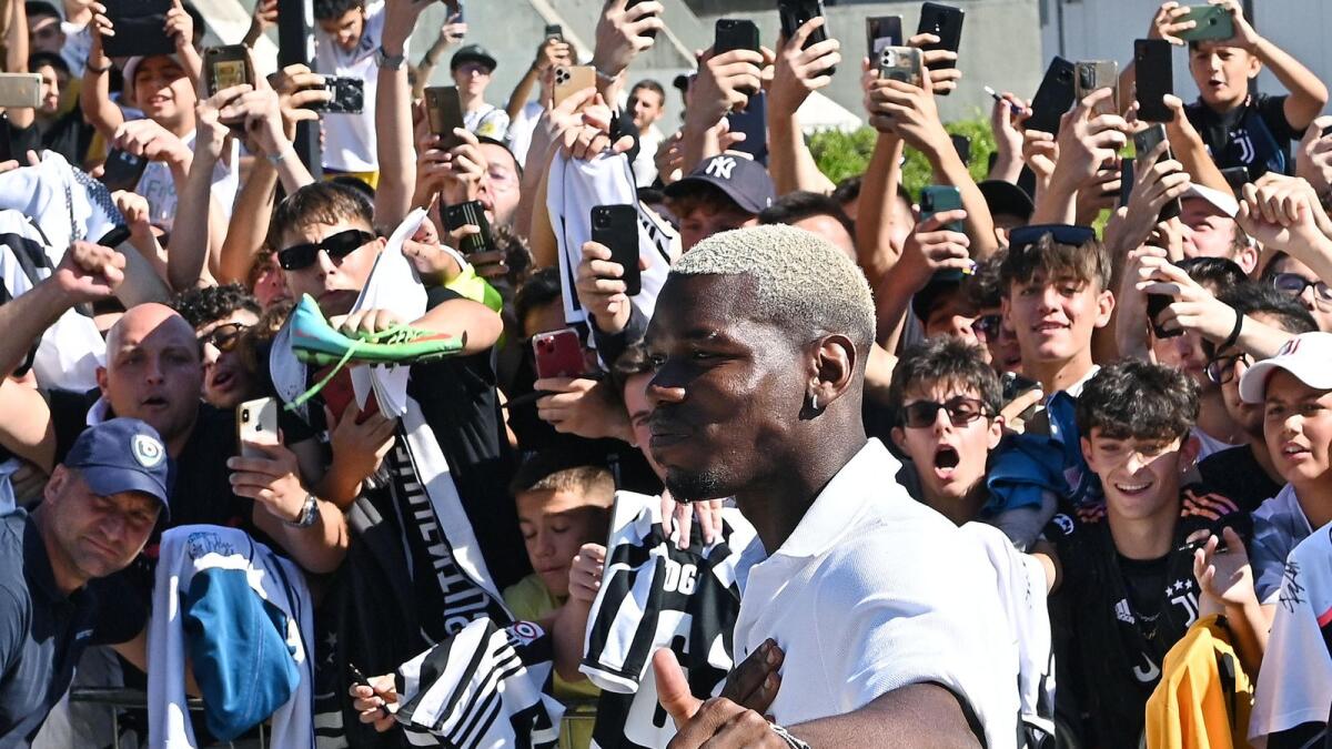 Paul Pogba greets supporters as he arrives at Juventus football club's Medical Centre in Turin. (AFP)