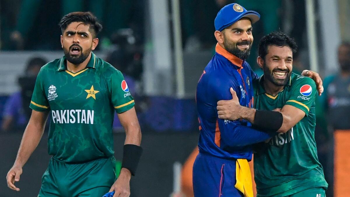 India's Virat Kohli (centre) congratulates Pakistan's Mohammad Rizwan (right) following their victory in the ICC T20 World Cup in Dubai on October 24, 2021. (AFP file)