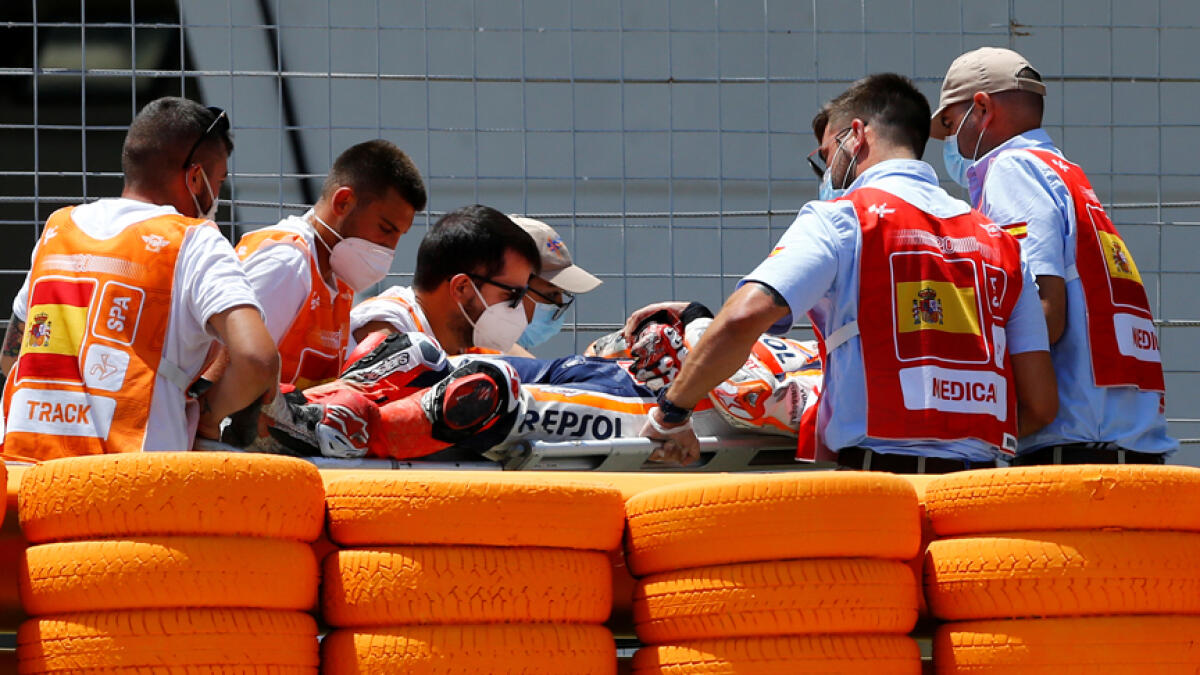 Repsol Honda's Marc Marquez is stretchered into an ambulance after crashing out during the race. - Reuters