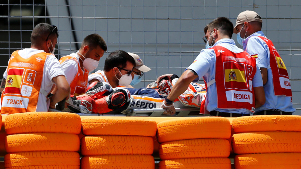Repsol Honda's Marc Marquez is stretchered into an ambulance after crashing out during the race. - Reuters