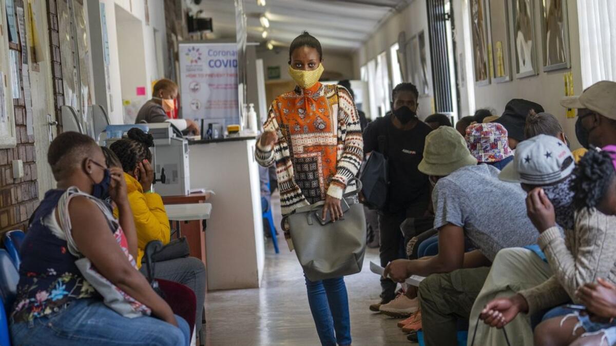 Volunteers wait to be checked at a vaccine trial facility for AstraZeneca at Soweto's Chris Sani Baragwanath Hospital outside Johannesburg, South Africa, Monday Nov. 30, 2020.