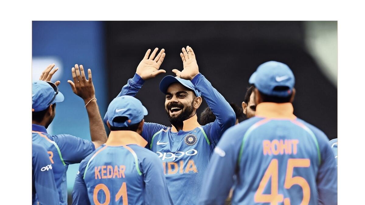 Virat Kohli (centre) celebrates with teammates.