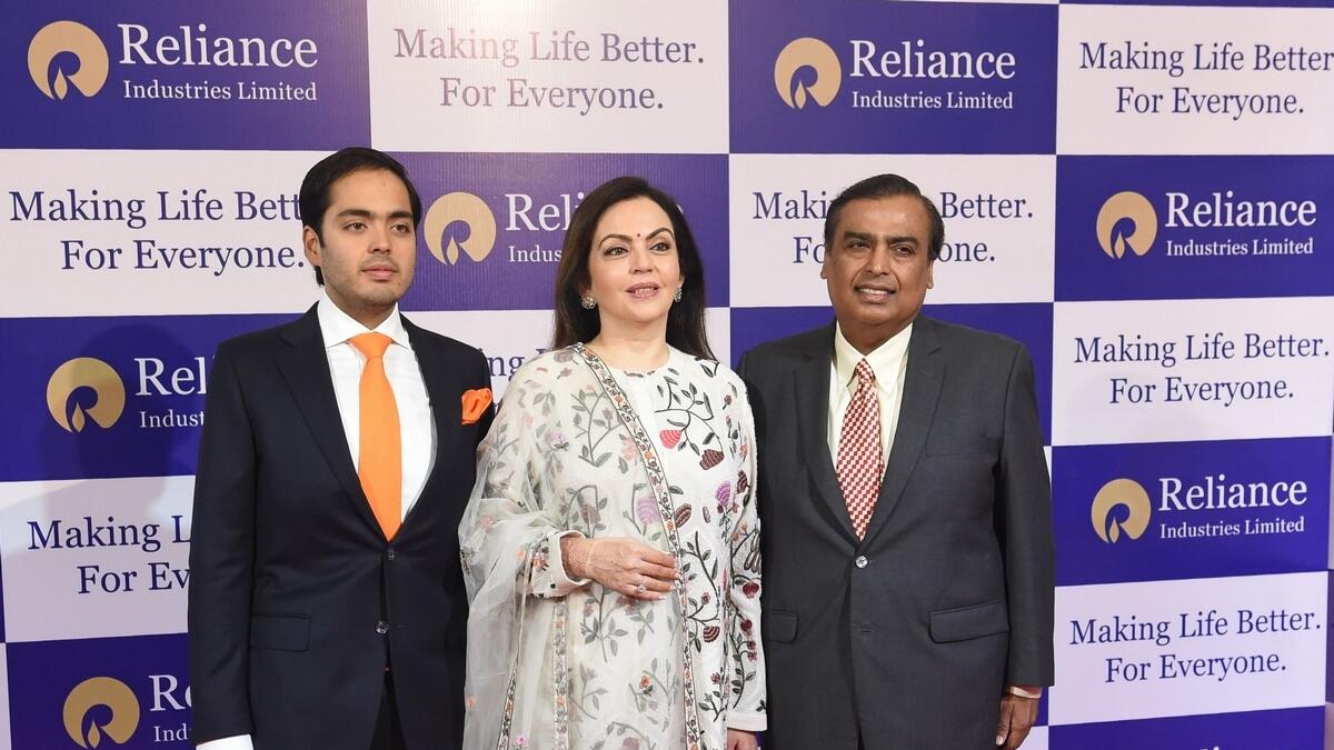 Reliance Industries chairman Mukesh Ambani (R) along with his wife Nita Ambani (C) and their son Anant Ambani arrive for the companys 41st AGM in Mumbai.-AFP
