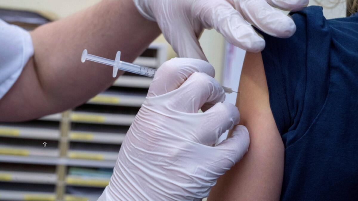 A girl is vaccinated with the Pfizer vaccine at the University Medical Centre in Rostock, Germany. — AP