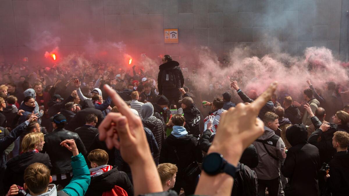 Ajax supporters celebrate outside the ArenA stadium as their team scored their second goal in the Dutch Eredivisie Premier League soccer match between Ajax and Emmen. — AP