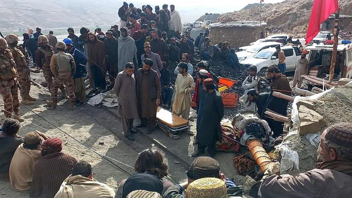 Miners gather outside the collapsed mine as rescue personnel conduct a search operation for trapped workers. — Photo: AFP / Mines and Minerals Development Department Balochistan