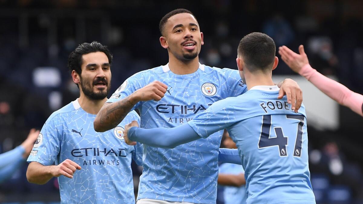 Manchester City's Gabriel Jesus (centre) celebrates his goal against Sheffield United with his teammates. — AP