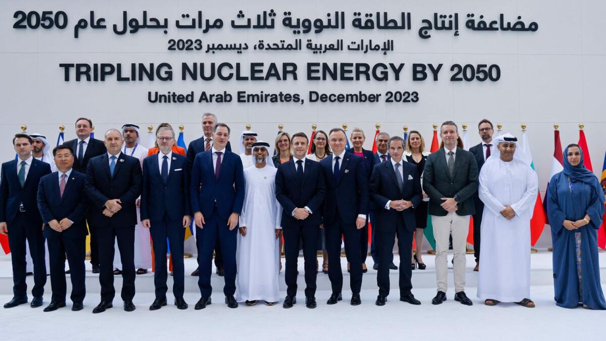 Emmanuel Macron (C) poses for a photo with other leaders and participants at the end of the Tripling Nuclear Energy by 2050 session at the United Nations climate summit in Dubai. - AFP