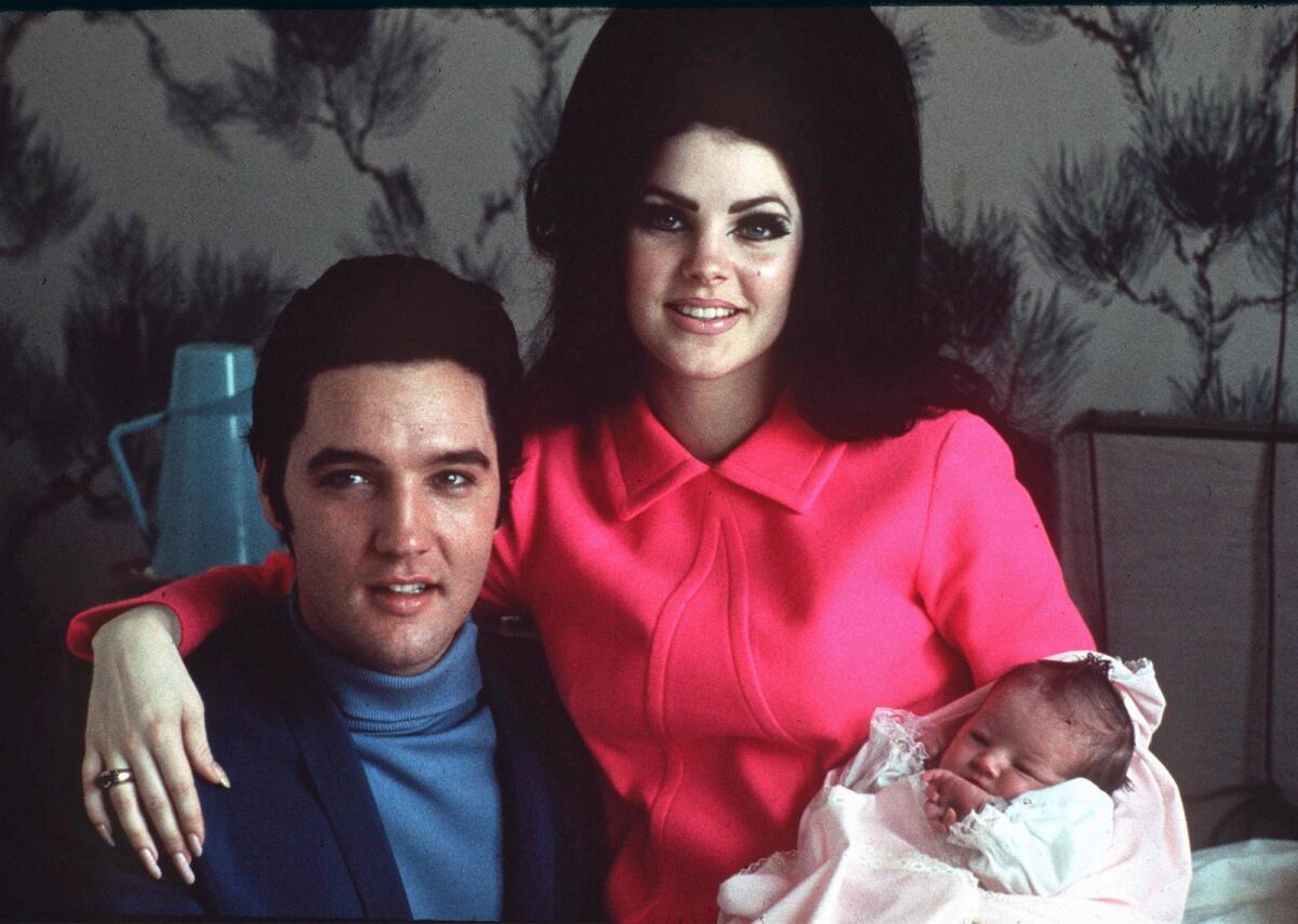 Elvis Presley poses with wife Priscilla and daughter Lisa Marie, in a room at Baptist hospital in Memphis, Tenn., on Feb. 5, 1968.