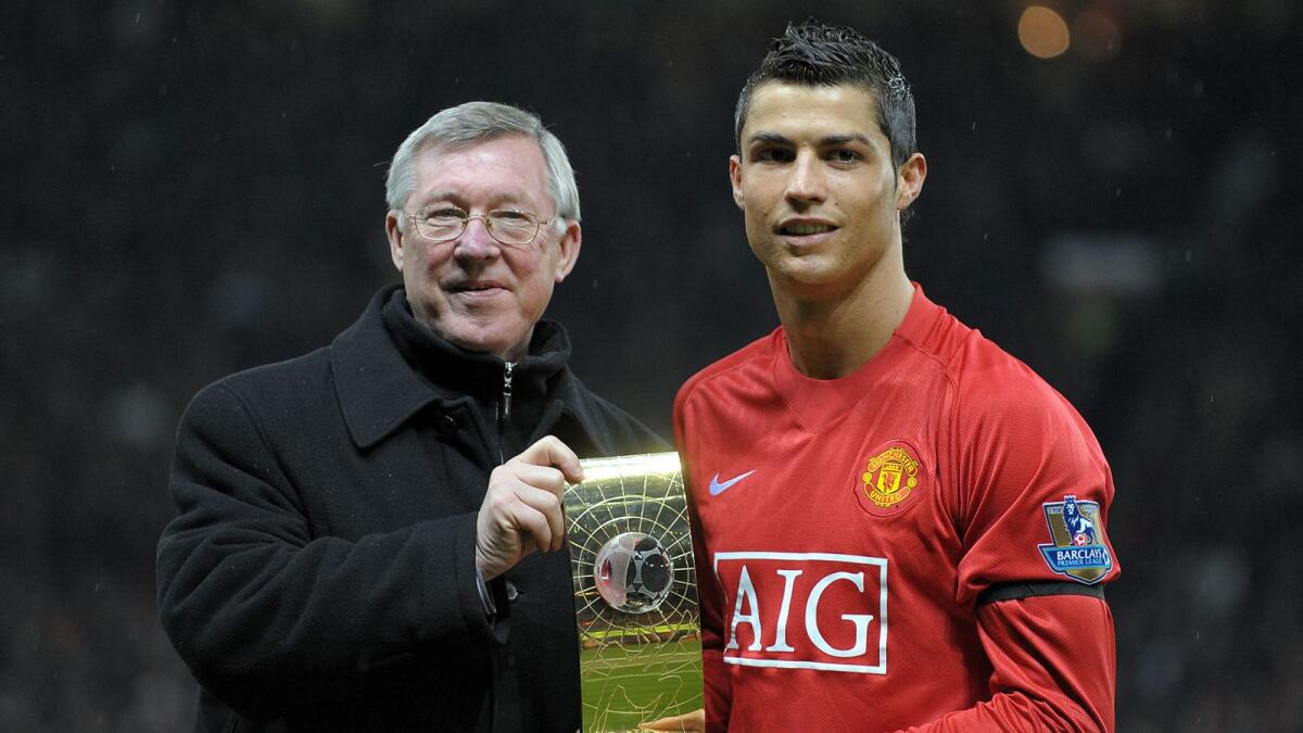 Cristiano Ronaldo poses with the Fifa World Player of The Year trophy with Alex Ferguson in 2009. (AFP file)