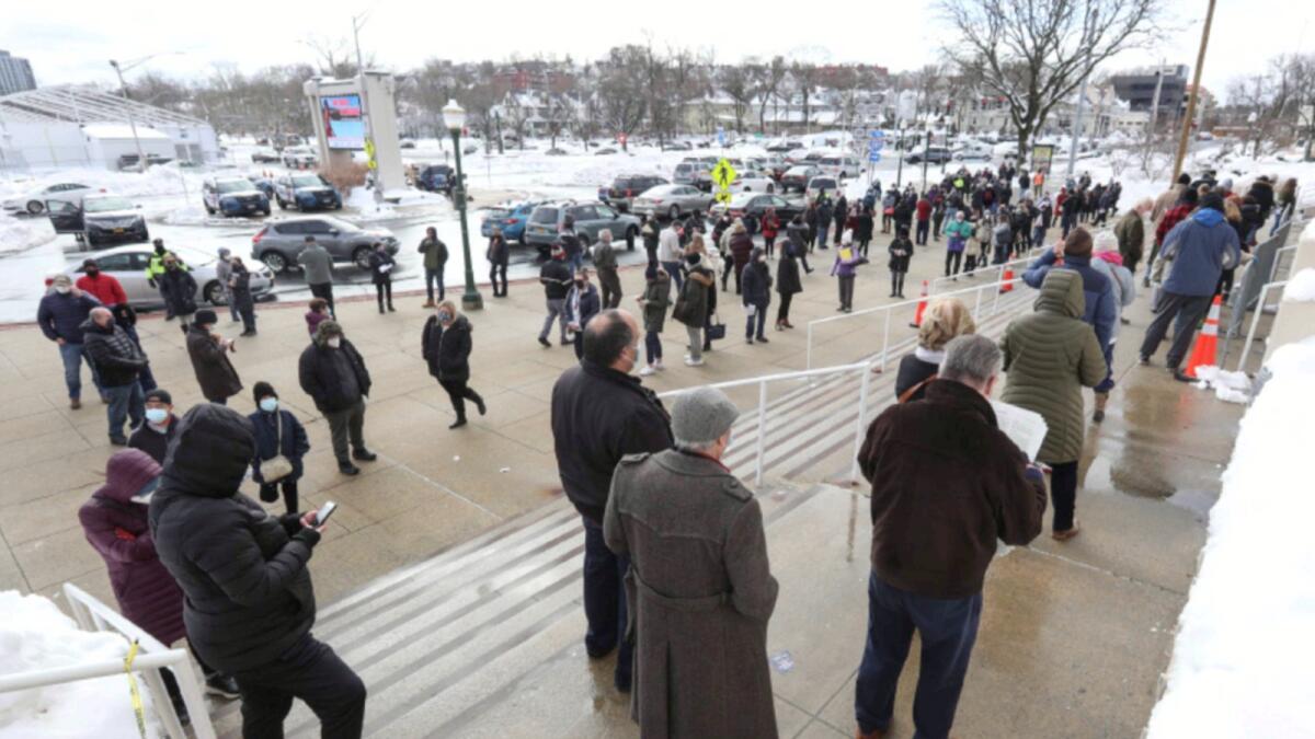 People wait outside the Covid-19 vaccination centre in Westchester County Center, New York. — AP