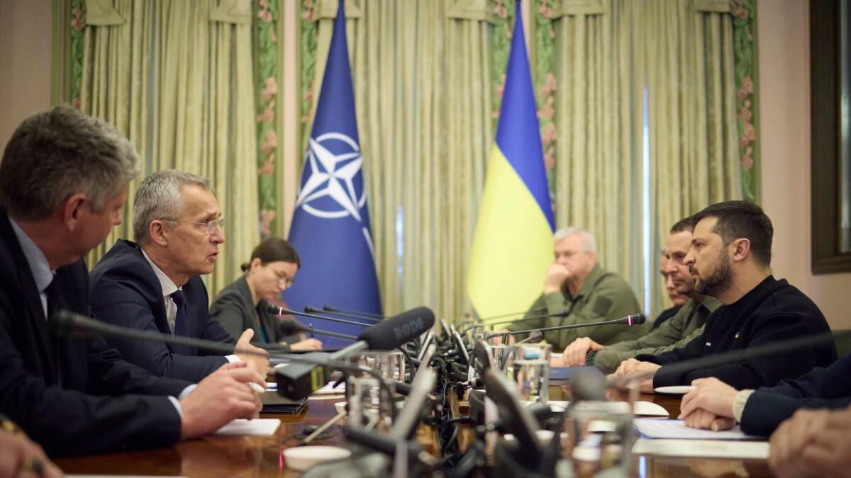 Nato Secretary General Jens Stoltenberg, second left, and Ukrainian President Volodymyr Zelenskyy, right, talk during their meeting in Kyiv, Ukraine, on Thursday. — AP