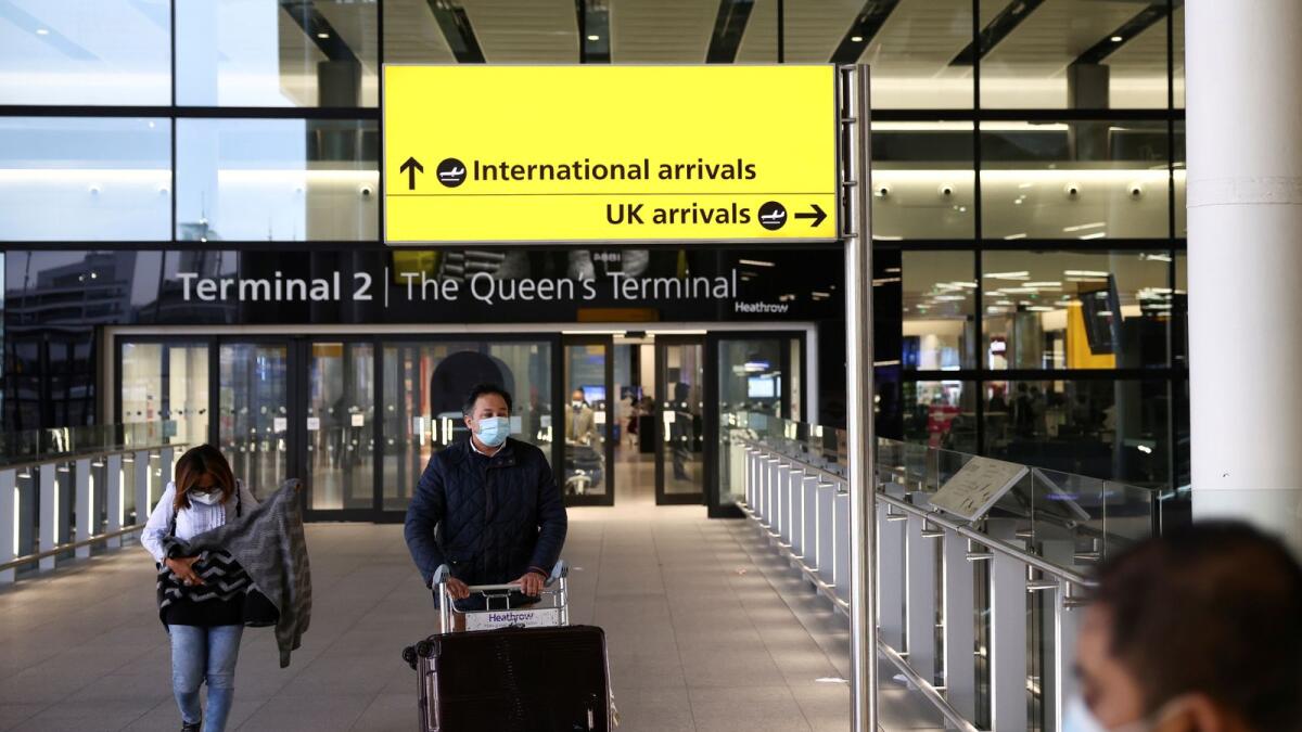 Travellers walk through Terminal 2 at Heathrow Airport, amid the coronavirus disease outbreak in London. Reuters