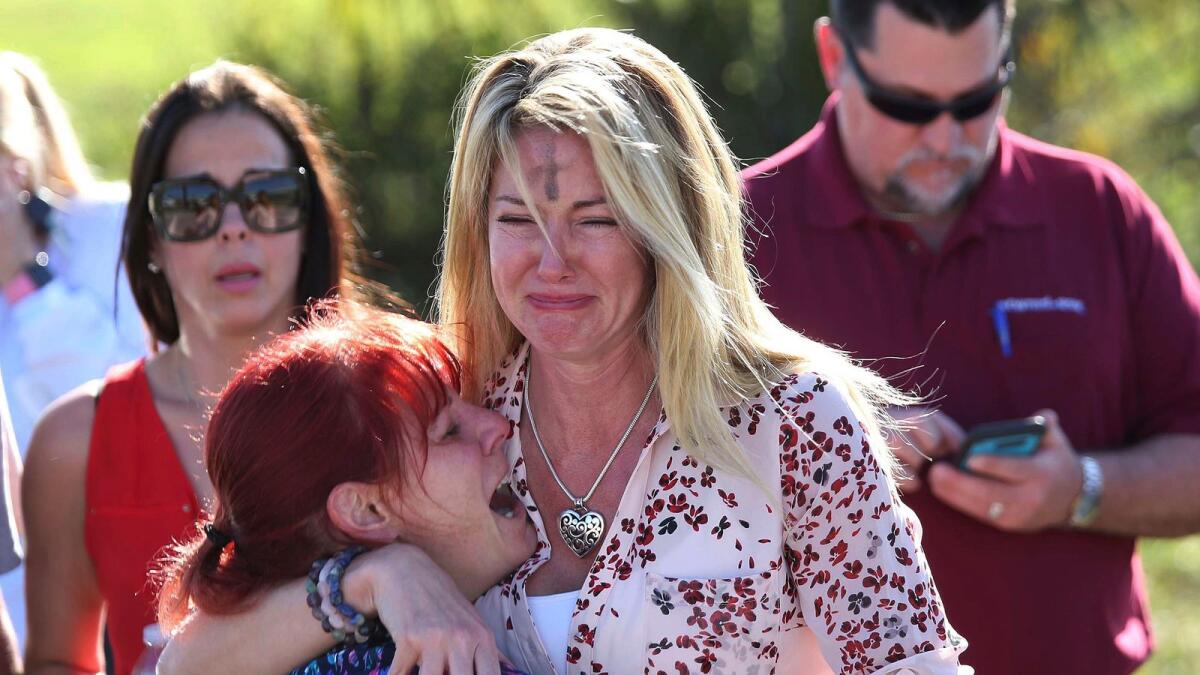 Parents wait for news after a reports of a shooting at Marjory Stoneman Douglas High School in Parkland, Flarida, on Feb. 14, 2018.