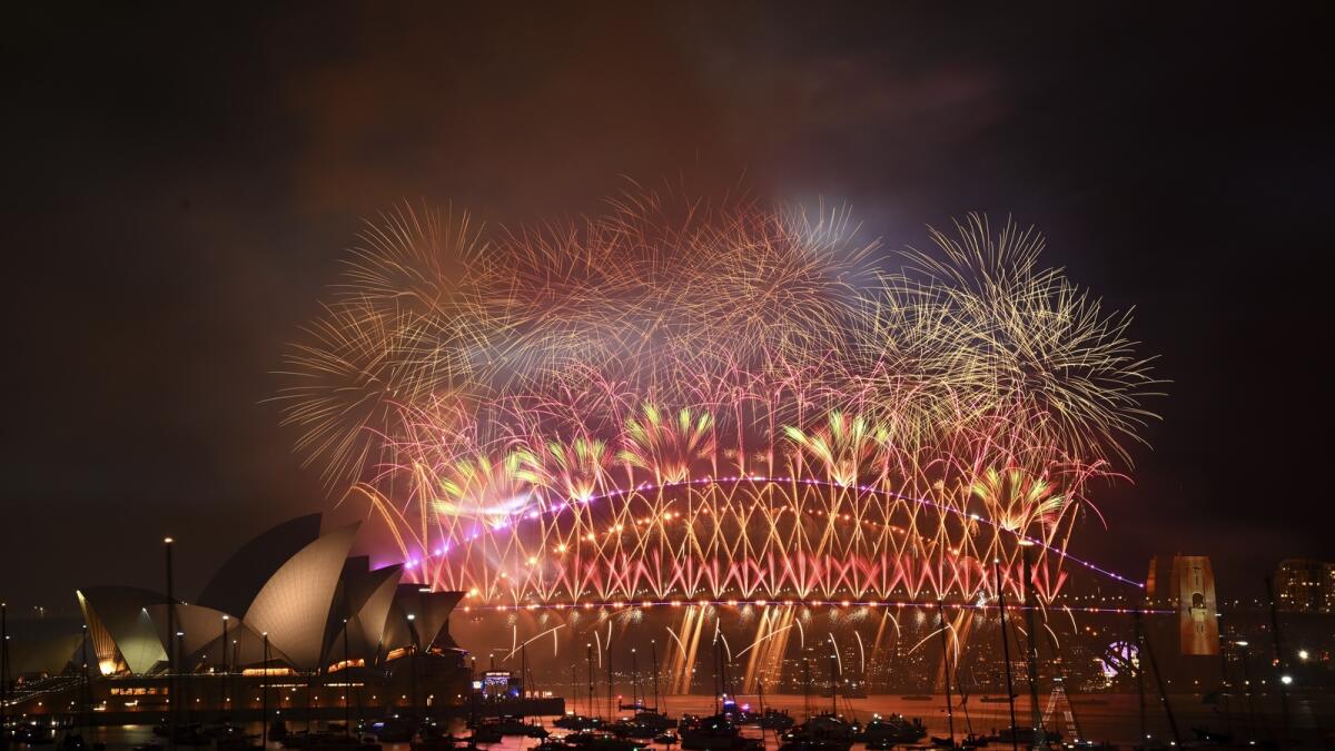 Fireworks explode over the Harbour Bridge as part of New Year's Eve celebrations in Sydney. — AP