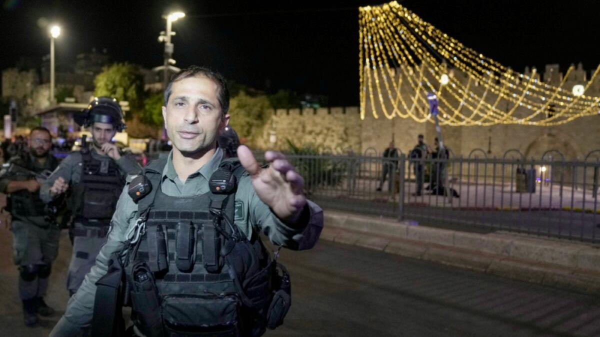 Israeli police officers clear the area outside Damascus Gate in Jerusalem's Old City. — AP