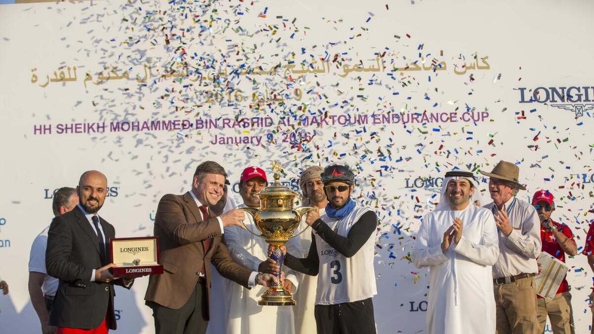 Shaikh Hamdan receives the winning trophy from Juan Carlos Capelli of Longines.